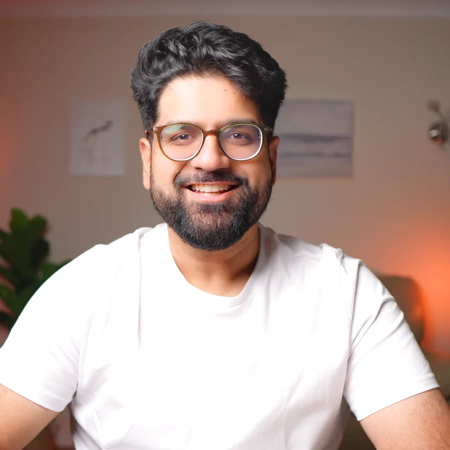 Rav Sawhney smiling, in a white T-shirt